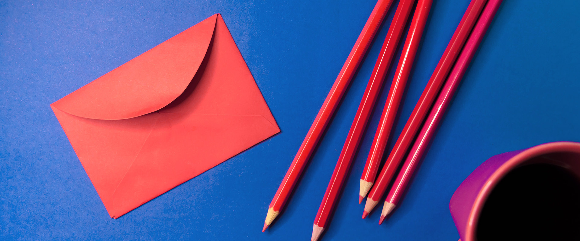 Envelope and pens on table ready to contact someone